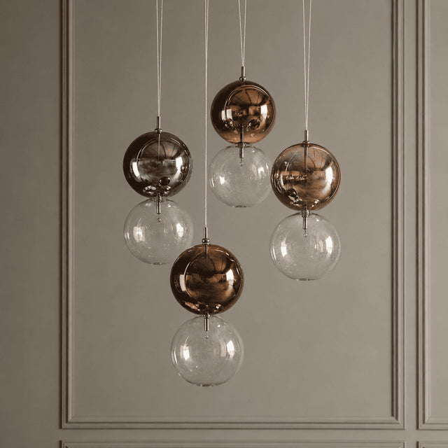Chandelier with glass and bronze spherical lights on a neutral background
