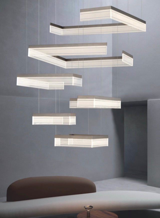 Modern pendant light fixture hanging against a gray wall