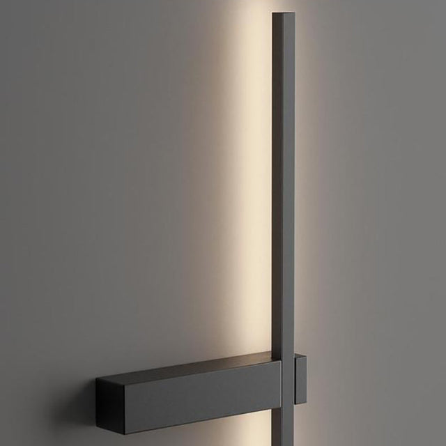 Modern wall-mounted light fixture on a gray wall