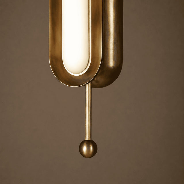Brass pendant light fixture on a brown background
