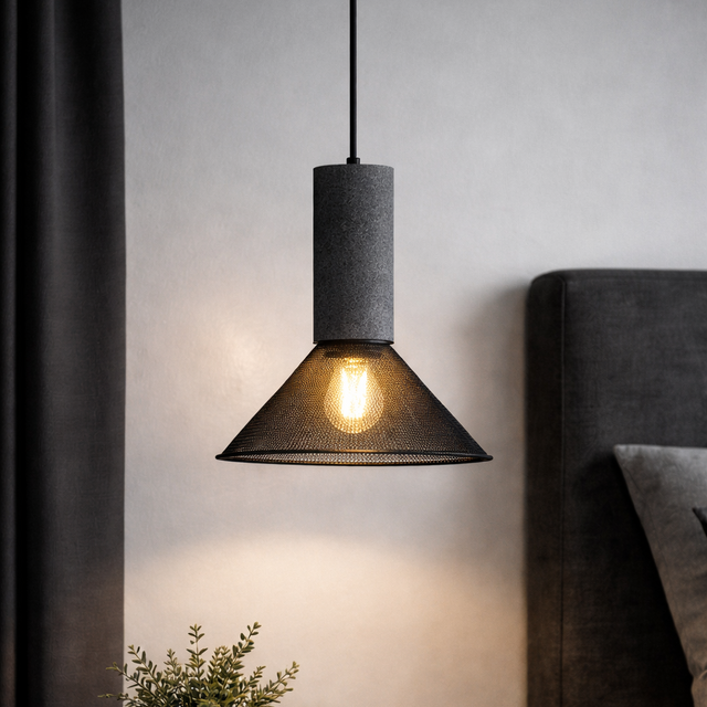 Pendant light fixture in a bedroom setting with a side table and decor items.
