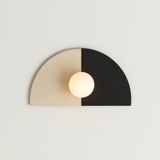Wall light fixture with half beige and half black design on a plain background