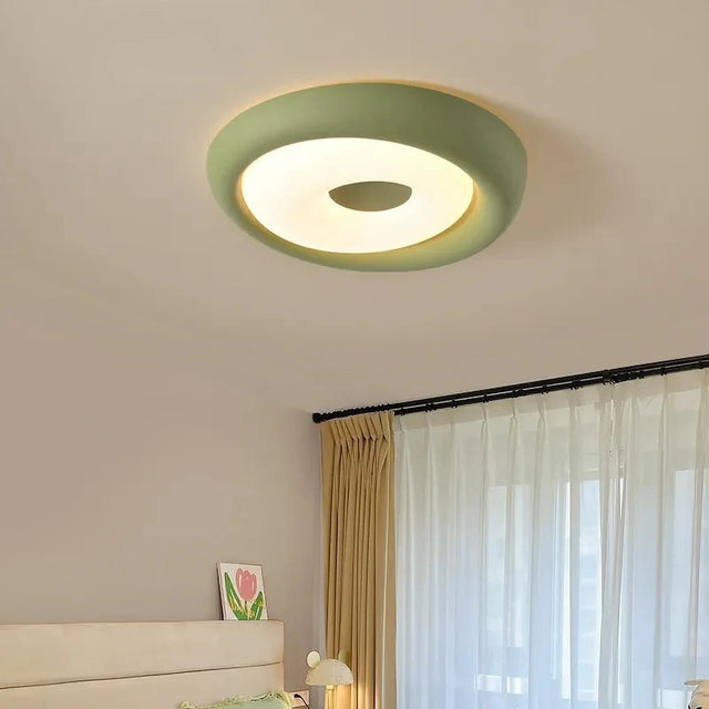 Ceiling light fixture in a room with a bed and window