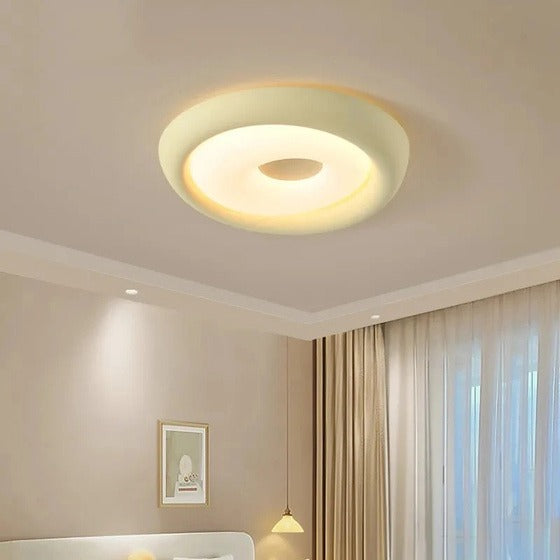 Ceiling light fixture in a room with neutral walls and curtains