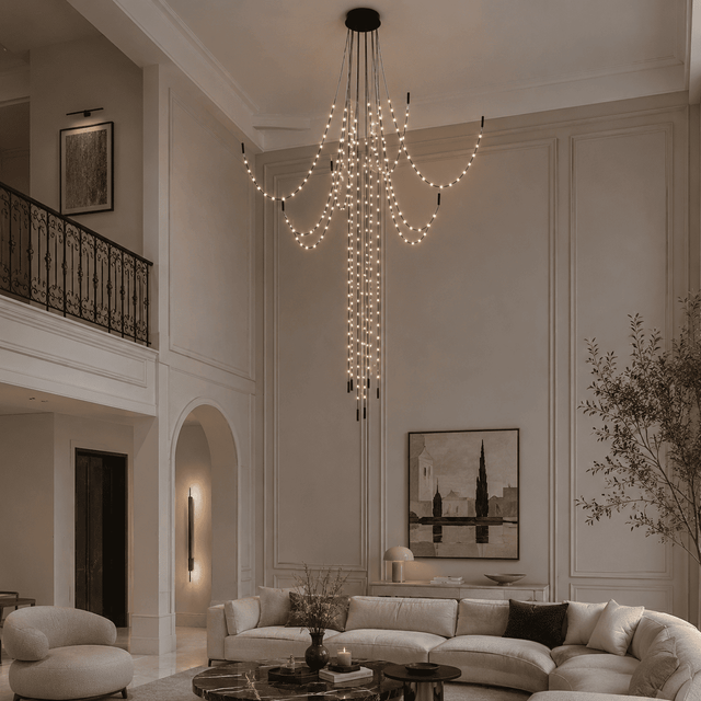 Luxurious living room with a large chandelier, white sofa, and decorative elements.