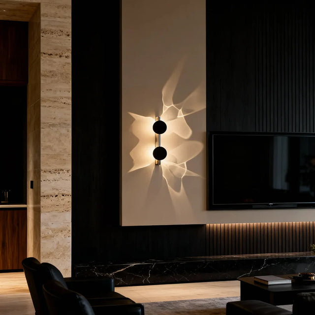 Modern living room with a wall-mounted light fixture and television.
