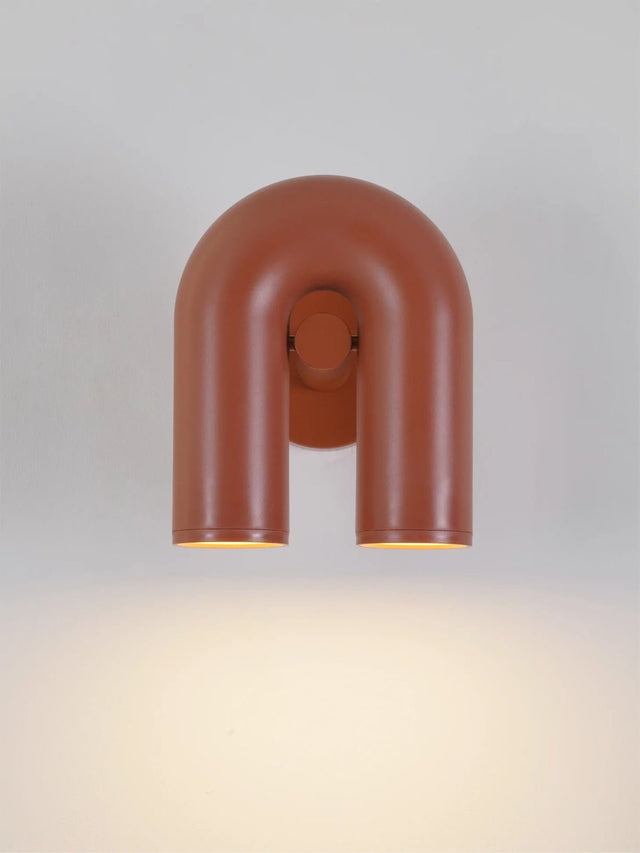 Modern wall-mounted light fixture with a U-shaped design on a neutral background