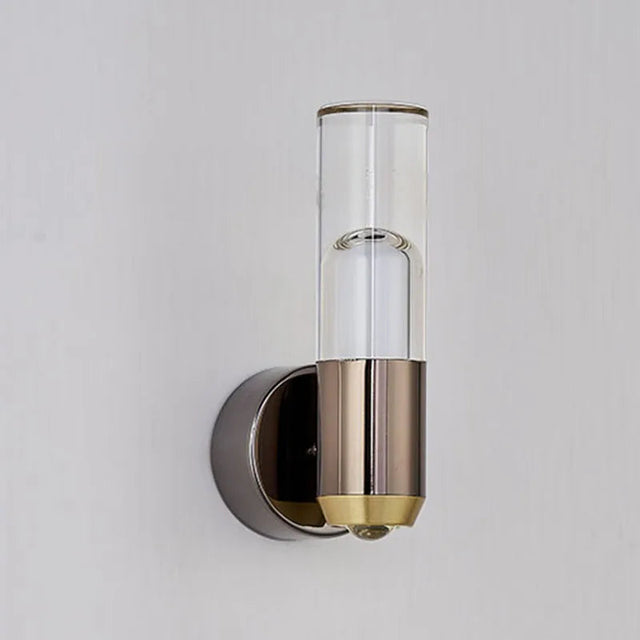 Wall-mounted light fixture with glass cover and metallic base on a gray background