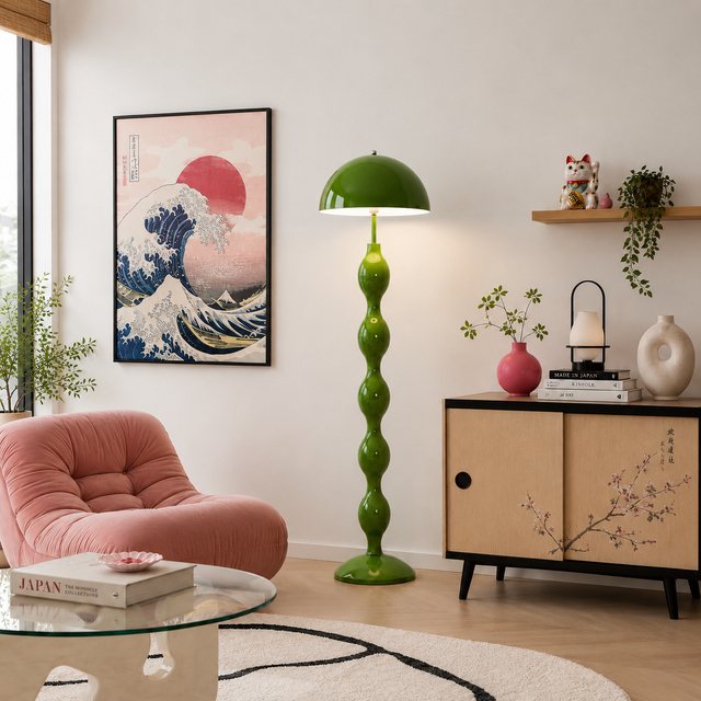 Living room with a pink armchair, green floor lamp, and decorative items.