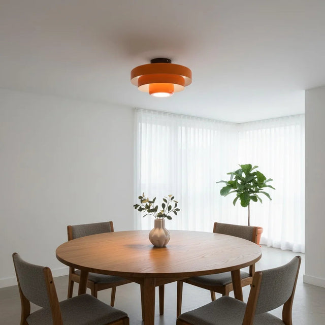 Dining room with a round wooden table and four chairs, featuring a ceiling light fixture.