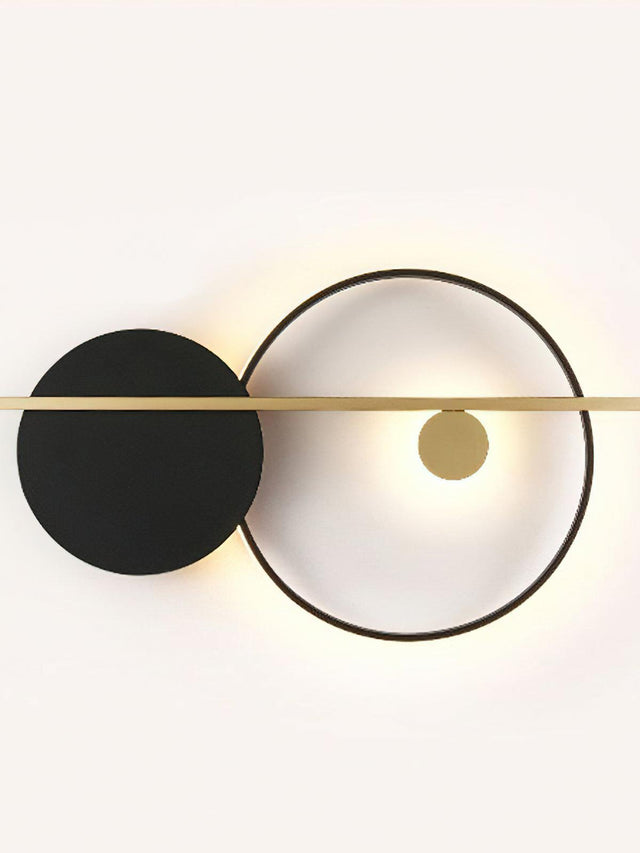 Modern wall light fixture with black and white circular design on a white background