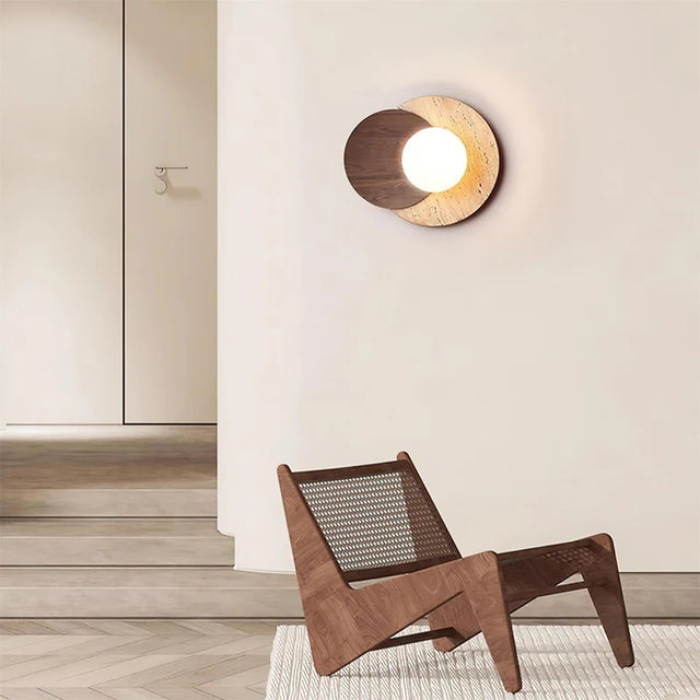 Wooden chair and wall light fixture in a minimalistic room.