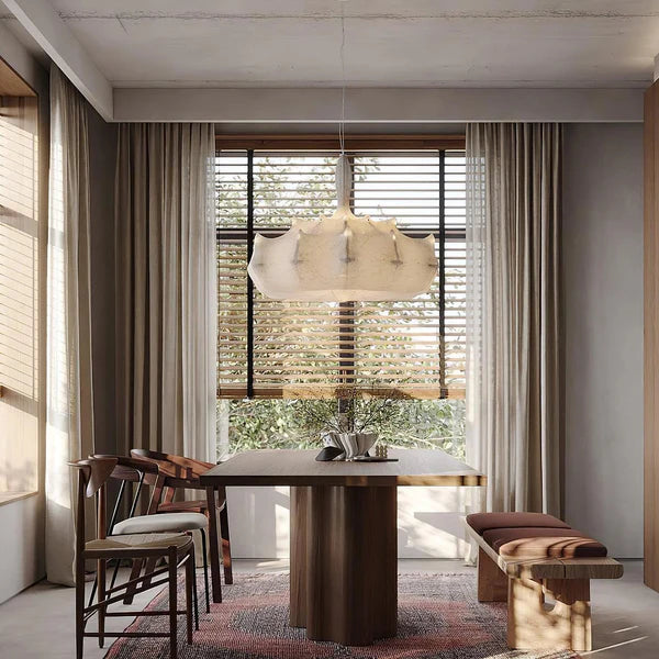 Modern dining room with wooden table, chairs, and pendant light.
