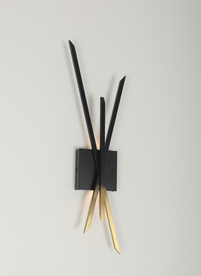 Modern wall clock with black and gold design on a gray background