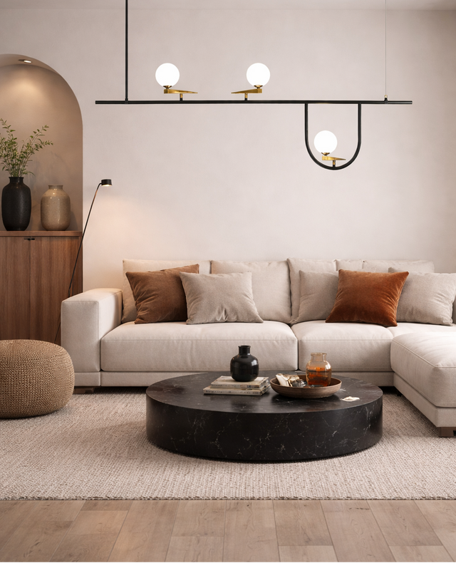 Modern living room with a sectional sofa, round coffee table, and decorative items.