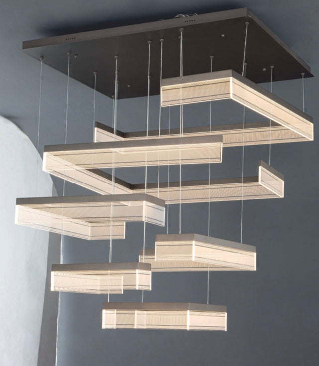 Modern chandelier with rectangular light fixtures on a gray background