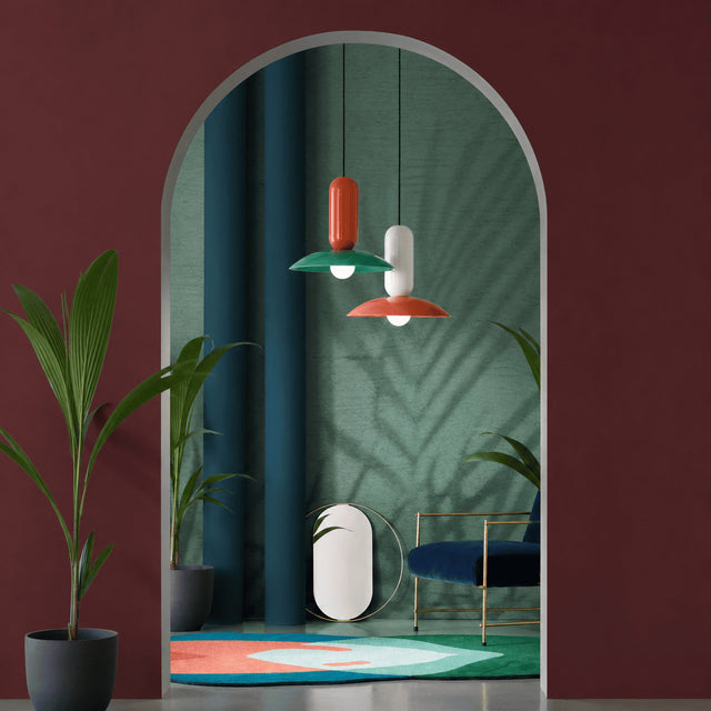Modern interior with colorful pendant lights, plants, and a decorative rug.