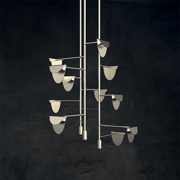 Decorative metal wall art with hanging elements on a black background