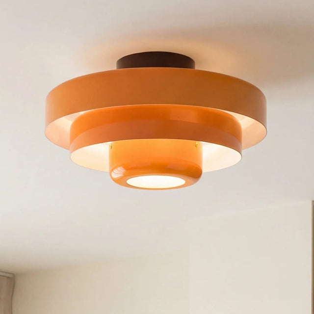 Orange ceiling light fixture on a white ceiling with 'at EASE' branding.