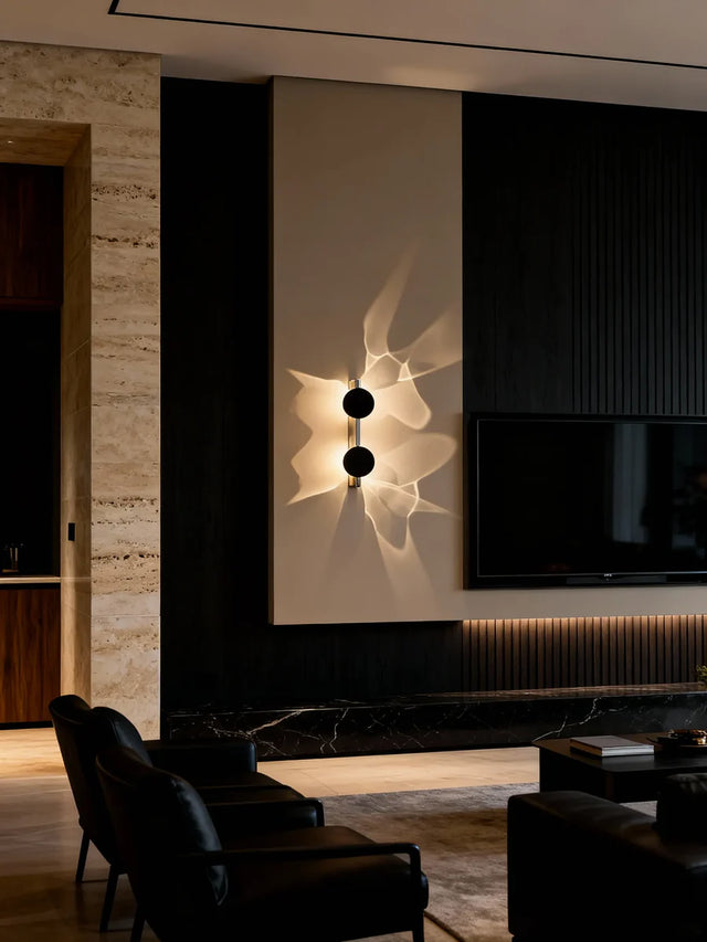 Modern living room with a wall-mounted light fixture and television.