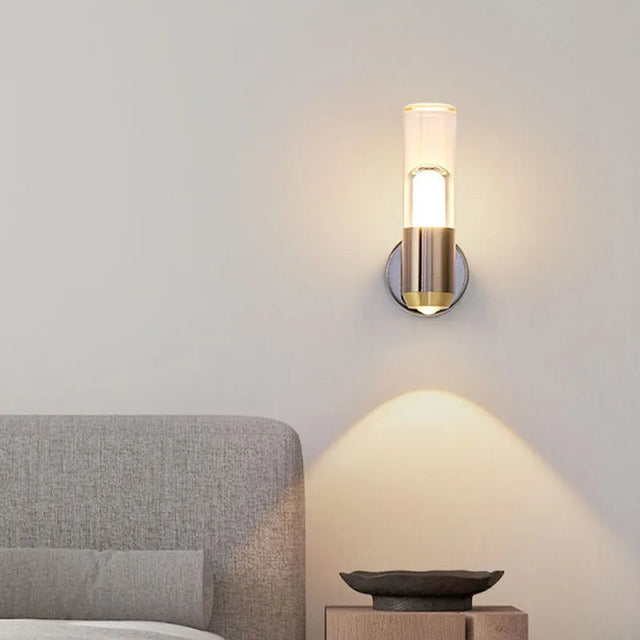 Wall-mounted lamp casting light on a bed in a bedroom setting