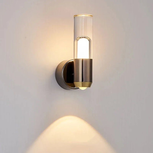 Gold wall-mounted light fixture on a gray background
