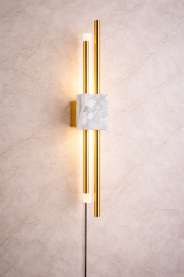 Modern wall sconce with gold finish and marble accent on a textured wall.