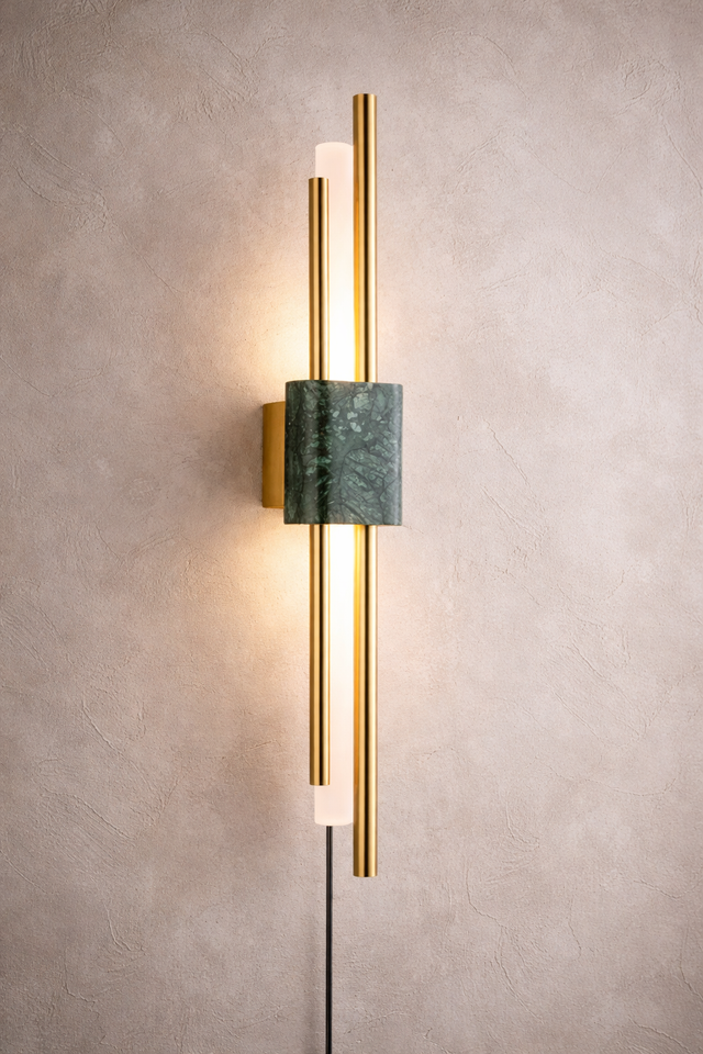 Modern wall lamp with gold and green design on a textured wall