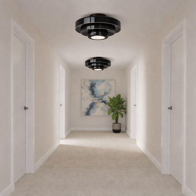 Modern hallway with black ceiling lights, abstract painting, and potted plant.