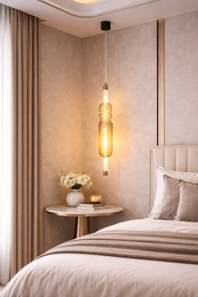 Modern bedroom with a pendant light, side table, and bed.