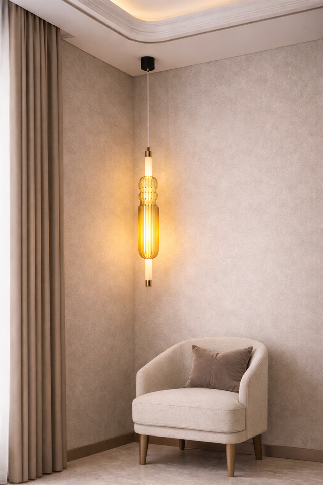 Modern interior with a beige armchair, textured wall, and pendant light.