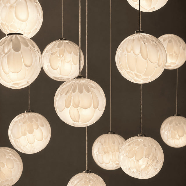 Close-up of multiple hanging light fixtures with a dark background