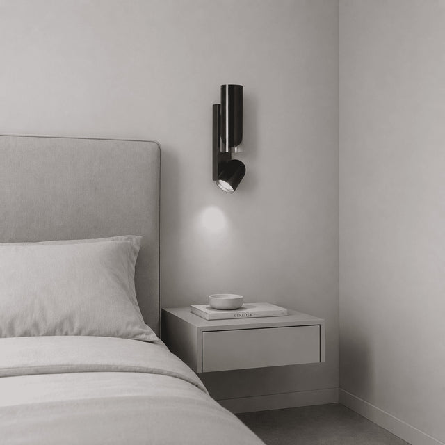 Modern bedroom with a bed, nightstand, and wall-mounted lamp.