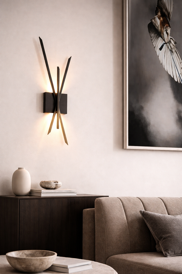 Modern interior design with wall lamp, sofa, and artwork on a light gray wall.