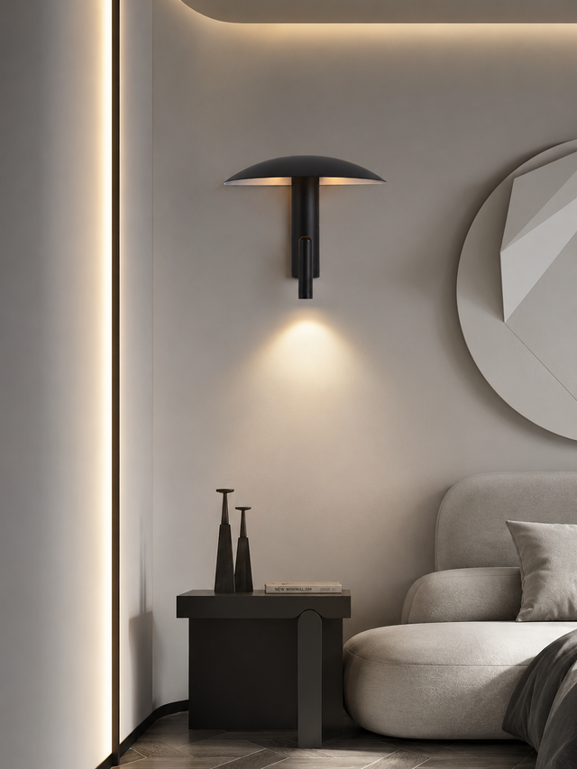 Modern interior design with a wall sconce, round mirror, and sofa.